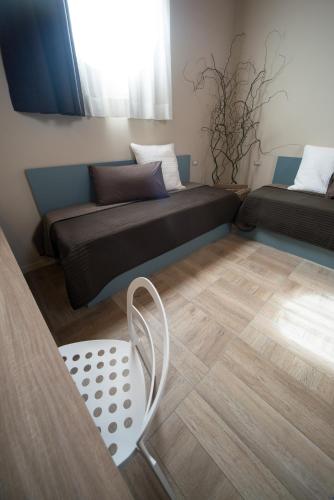 a living room with a couch and a chair at Agriturismo La Galizia in Cuggiono