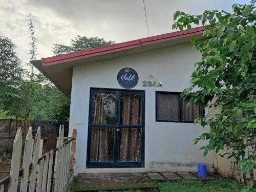a building with a sign on the door of it at JenJon Karjat Resort - One BHK Premium Chalet with optional SWIMMING POOL in Karjat