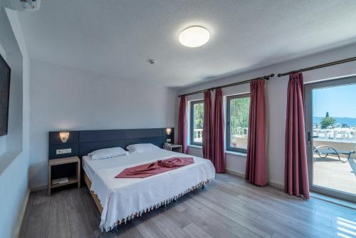 Un dormitorio con una cama y una ventana grande en laden hotel bodrum, en Bodrum City