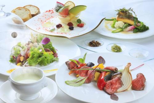 a table with plates of food and a cup of tea at Yutorelo Karuizawa Hotel in Karuizawa