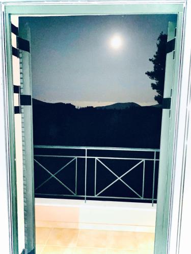 a sliding glass door with a view of the moon at 350m Above Sea in Vasiliki