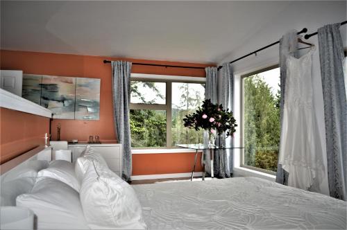 a bedroom with a white bed and a large window at Armand Heights in Ganges