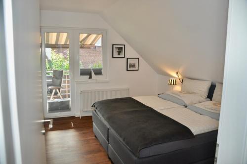 een slaapkamer met een bed en een raam bij Am Alten Leuchtfeuer in Eckernförde