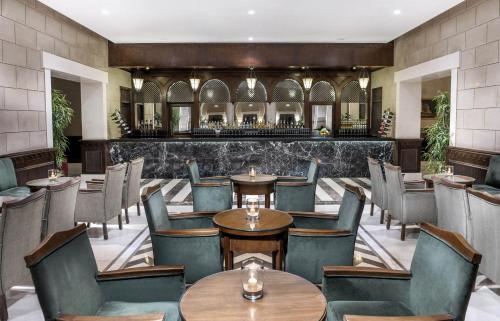 a restaurant with tables and chairs and a bar at JAZ Belvedere in Sharm El Sheikh