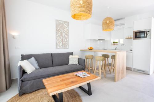 a living room with a couch and a table at Alkithea luxury suites in Karpathos Town