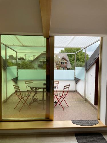 a view from the window of a house with a table and chairs at undertheroof at in Salzburg