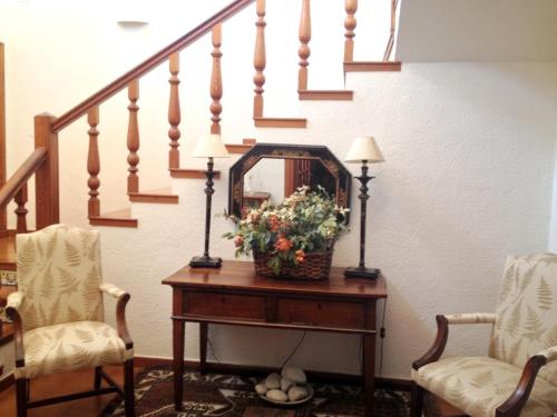 a hallway with a table with a mirror and flowers at Seaside villa in Jávea with private pool in Jávea