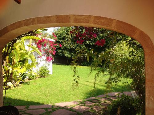 an archway with a garden with flowers on it at Seaside villa in Jávea with private pool in Jávea