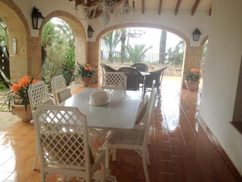 a dining room with a table and chairs at Seaside villa in Jávea with private pool in Jávea
