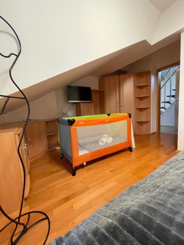 a bedroom with an orange bed and a tv at undertheroof at in Salzburg