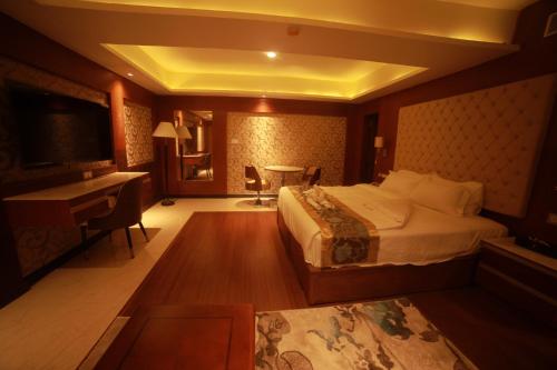 a hotel room with a bed and a desk at THE HOTEL PARK in Kolachel