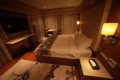 a hotel room with a large bed and a television at THE HOTEL PARK in Kolachel