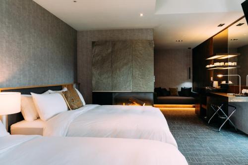 a hotel room with two beds and a desk at Tsang Kuo Resort in Wujie