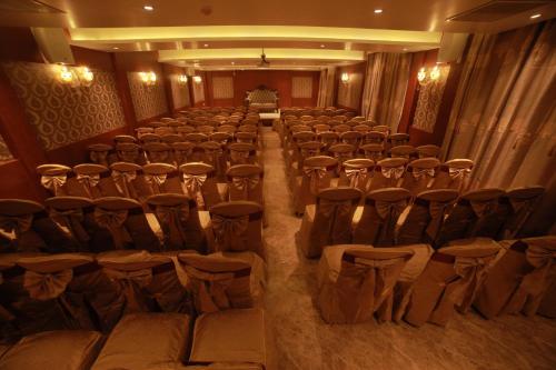an auditorium with chairs and tables in a room at THE HOTEL PARK in Kolachel