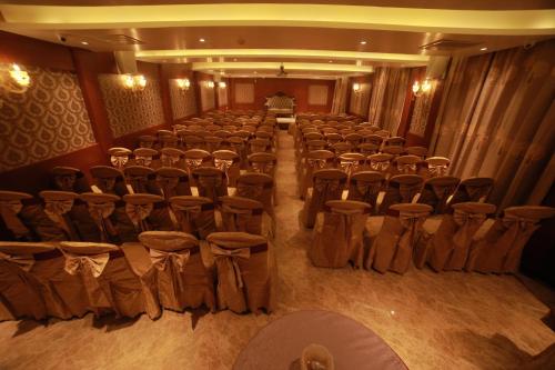 a room with chairs and tables and a man in a room at THE HOTEL PARK in Kolachel