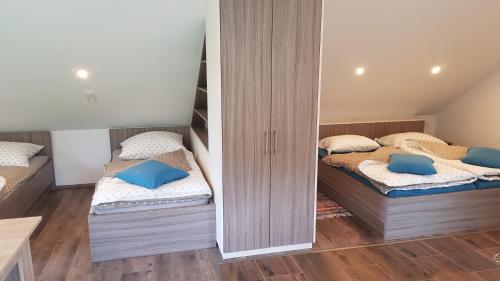 two twin beds in a room with twounks at Apartma Cifra Begunje in Begunje na Gorenjskem