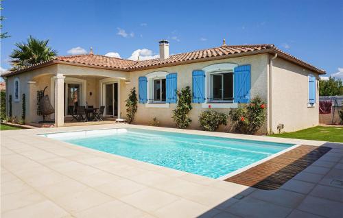 a house with a swimming pool in front of a house at Stunning Home In Puisserguier in Puisserguier
