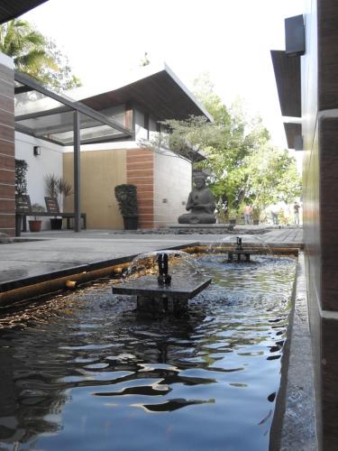 a pond in the middle of a building at Lago Leisure Resort & Spa in Cherai Beach
