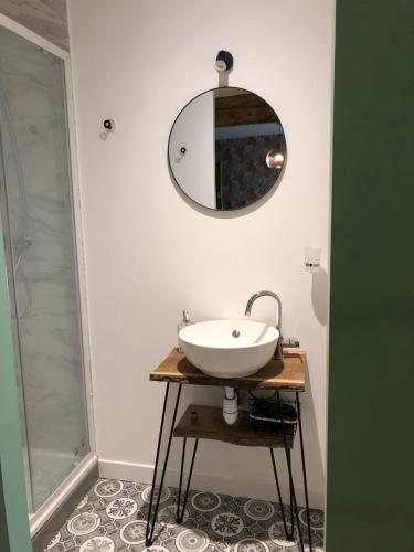 a bathroom with a sink and a mirror on the wall at L 'Air d'Aspe in Accous