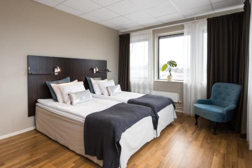 Säng eller sängar i ett rum på Hotell Fyrislund