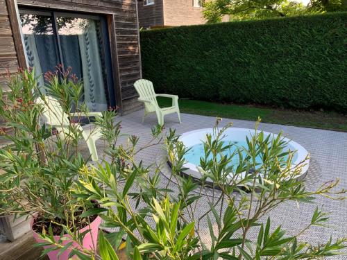 a patio with a white chair and a table and a chair at Le Lagon in Jargeau