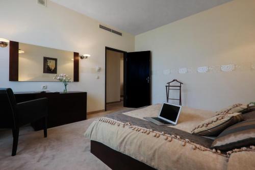 a bedroom with a bed with a laptop on it at Hotel Borowiecki in Łódź