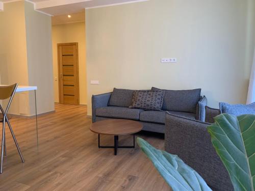 a living room with a couch and a table at eleven in Jūrmala