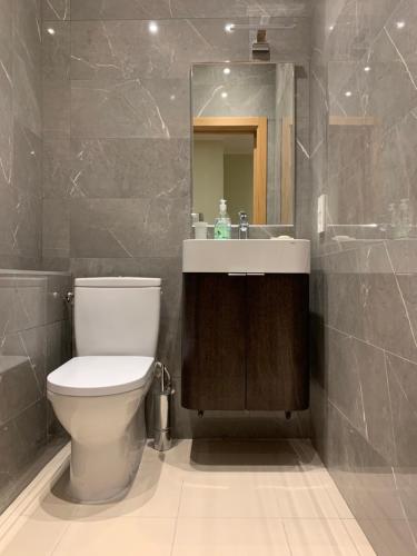 a bathroom with a toilet and a sink and a mirror at eleven in Jūrmala