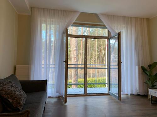 a living room with a large sliding glass door at eleven in Jūrmala