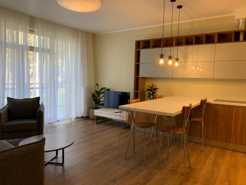 a kitchen and living room with a table and chairs at eleven in Jūrmala