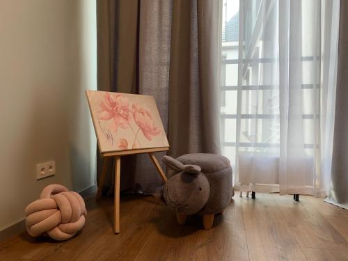a childs room with a painting and a stuffed animal at eleven in Jūrmala