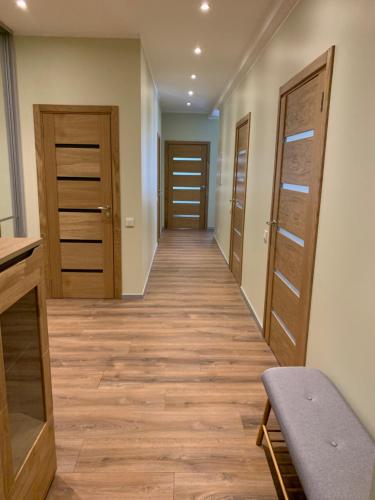 a hallway with wooden doors and wooden floors at eleven in Jūrmala