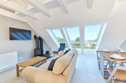 a living room with a couch and a table at Host & Stay - Castle View in Seahouses