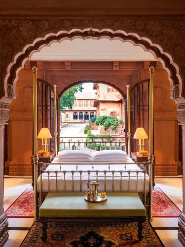 a bedroom with a bed in an archway at The Laxmi Niwas Palace in Bikaner