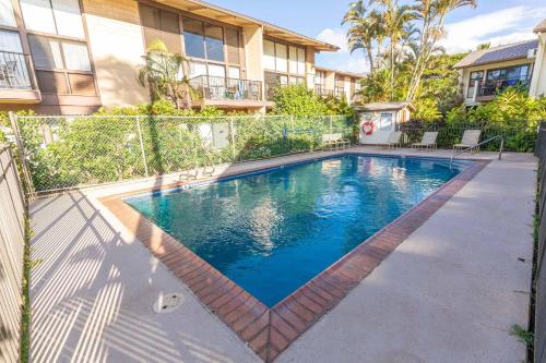 a swimming pool in the backyard of a house at Makani A Kai Resort B-7 in Wailuku