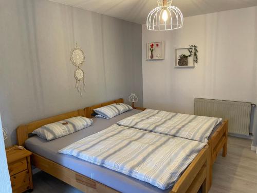 a bedroom with a large bed with two pillows at Ferienwohnung Schwarze in Duderstadt