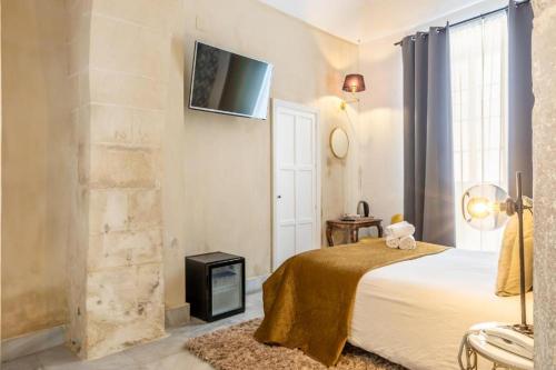 Giường trong phòng chung tại Catedral Suites Jerez