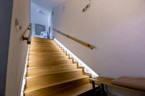 a staircase in a house with wooden floors at WX Hotel in Bratislava
