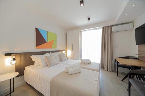 a bedroom with a large white bed and a table at 9 apartments in Jagodina