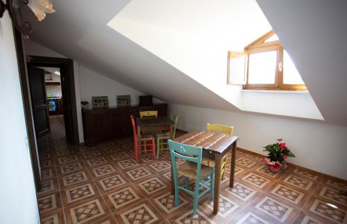 a room with a table and chairs in a attic at Albergo Ad Astra in Pescasseroli