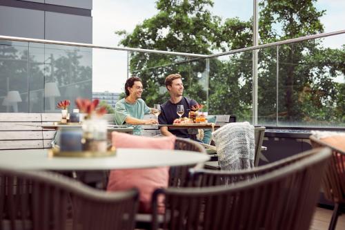 two people sitting at a table in a restaurant at Van der Valk Hotel Haarlem in Haarlem