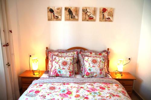a bedroom with a bed with pillows and two lamps at Villa Ensueño with private pool and large garden in Mazarrón