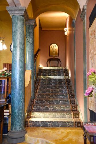 a set of stairs in a building with columns at Hotel Terme in Sarnano