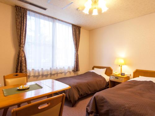Кровать или кровати в номере Hotel Seikoen