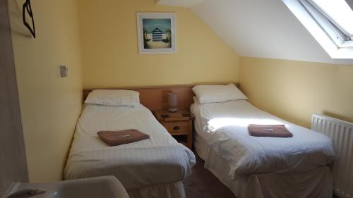 Ένα ή περισσότερα κρεβάτια σε δωμάτιο στο The Beacon Hotel
