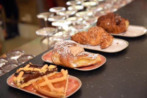a table with three plates of pastries on them at Hotel Terme in Sarnano