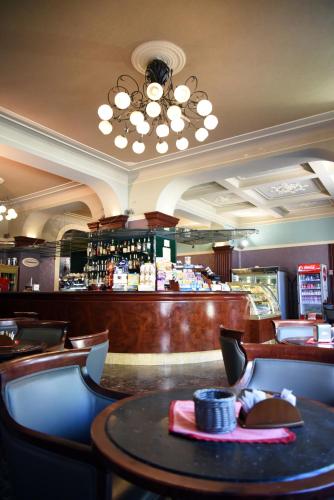 a restaurant with a bar with a table and chairs at Hotel Terme in Sarnano