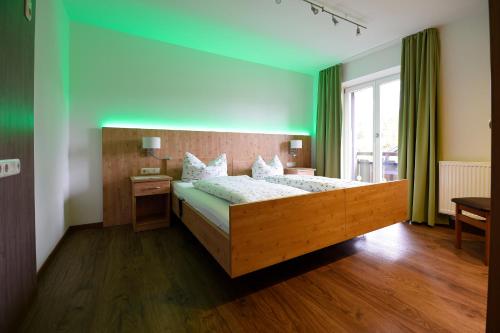 a bedroom with a large bed and a window at Neureuth in Bad Wiessee