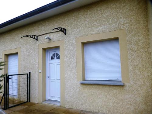 a house with a white door and a window at Gite de Parcey in Parcey