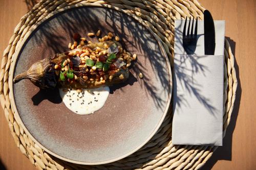 a plate of food with a meal on a table at Asterion Suites & Spa - Designed for Adults in Gerani Chanion